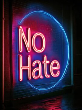Bright neon sign displaying no hate message in urban setting during night time