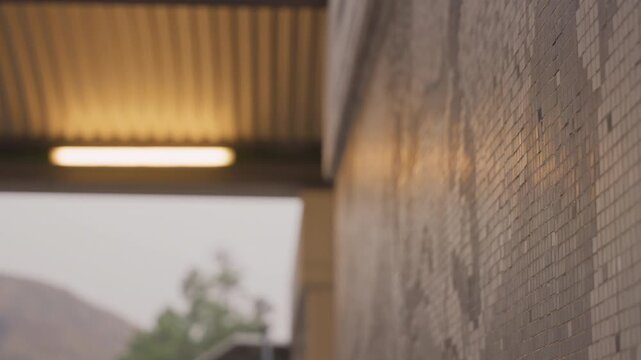 Reflective ceramic tiles with subtle grout lines. Cinematic focus on textured mosaic tile surface in shelter. Closeup of warm glow mosaic tiles with reflective surfaces and quiet shelter ambiance