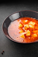 Red soup vegetables potatoes, tomato, broth first course borscht tasty snack fresh delicious gourmet food background on the table rustic food top view copy space  vegetarian and vegan food