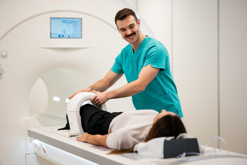 Radiographer preparing patient for mri knee scan