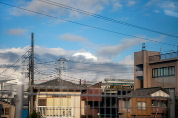Japanese Urban Residential Buildings with Distant View of Mount Fuji under Blue Sky, Japan