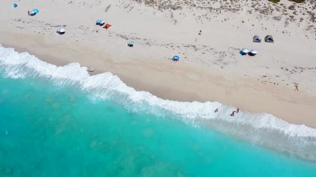 Nudist beach in Greece. Naked people man an woman naturist at beautiful ocean aerial drone shot