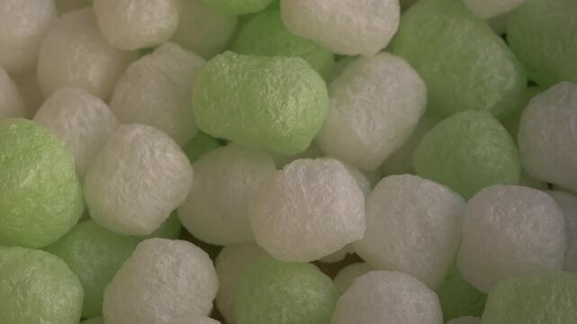 Biodegradable starch foam peanuts in various shapes and sizes, showcasing eco-friendly packaging materials in a close-up view. Ecofriendly packaging