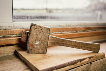 wooden mallet placed on a workbench. traditional hand tool used in woodworking, carpentry and...