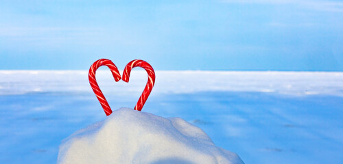 Fototapeta premium Candy heart on a frozen lake, endless snowy expanses, winter travel, I love winter background.