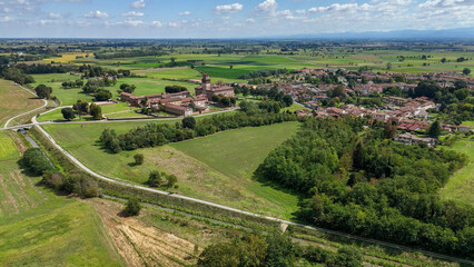 Naklejka premium Chignolo Po, Pavia, Italy, historic Lombardy landmark, providing a heritage backdrop for rural Italian countryside and surrounding agricultural fields
