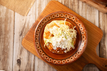 Tinga toast, a traditional Mexican home-cooked dish consisting primarily of chicken or beef cooked with chipotle chili and lots of onion, is traditionally eaten on "Tostadas" (fried corn tortillas).