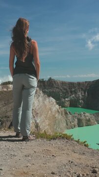 Female tourist is enjoying a stunning view of the taal volcano crater lake, a popular tourist destination in the philippines