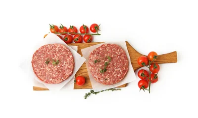 Fotobehang Onderzeeër Uncooked meat patty with thyme and tomatoes isolated on white, top view  © New Africa