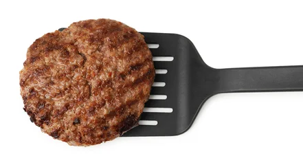 Fototapete Zu Essen Spatula with delicious grilled meat patty isolated on white, top view  © New Africa