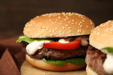 Fotobehang Eten Delicious burgers with meat patties on wooden table, closeup  © New Africa