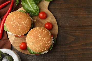 Fotobehang Eten Delicious burgers with meat patties on wooden table, flat lay. Space for text  © New Africa