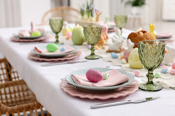 Easter celebration. Festive table setting with painted eggs indoors, closeup