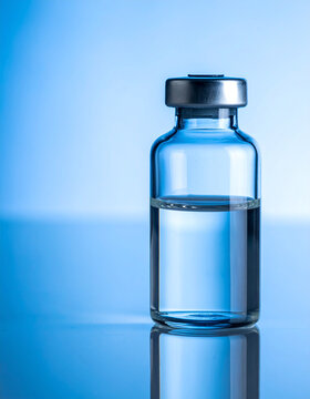 Transparent glass vial filled with clear liquid, healthcare and pharmaceutical treatment concept, clean