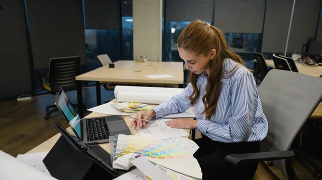 Professional interior designer working on blueprint in modern office