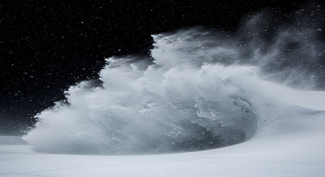 Snow blowing in the wind, creating a swirling vortex of white powder snow against a dark background, captured from a low viewpoint