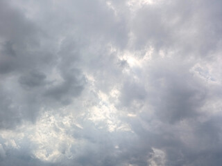 Fototapeta premium Dramatic Overcast Sky with Dark Stormy Clouds and Soft Sunlight Peeking Through, Moody Gray Atmosphere Background for Nature and Weather Concepts