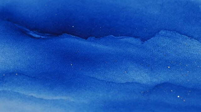 Deep blue watercolor painting with glittery speckles, evokes a celestial or fluid essence