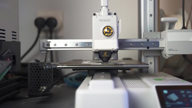 3D printer working on a high-precision model with plastic material for printing a toy