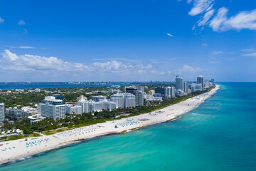 Drone aerial view of Miamis sandy beach. Miami coastline. Wide drone shot of Miami Beach and ocean waves. Miami beachscape captured from above. Oceanfront Miami resorts by drone. © be free