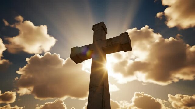 Cross illuminated by sunlight against dramatic clouds for Easter celebration. Symbolic cross stands tall with rays of light shining through clouds,