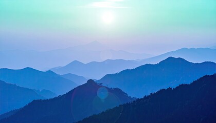 Obraz premium Layered blue mountain peaks fade into a hazy horizon under a pale sun