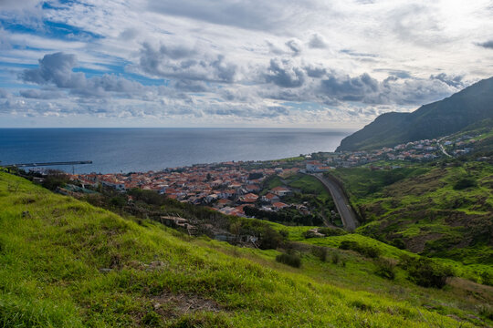 Viewpoint Calhau da Furna do Bode on Madeira, green hills meet sea, discovery archipelago landscape, volcanic island travel, adventure vacation, colorful rooftops, Madeira, Portugal