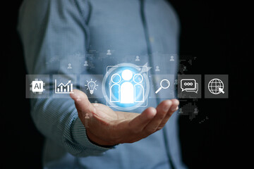 Businessman hand holding target customer AI analytics with icons, concept of Digital marketing, human resource management, customer data analysis, recruitment technology, teamwork, modern business.