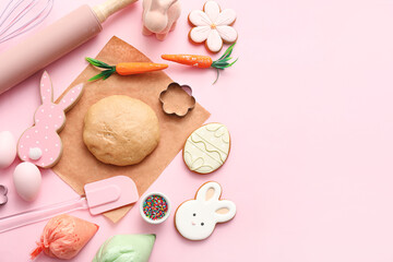 Fresh dough with Easter cookies, piping bags, eggs and kitchen utensils on pink background