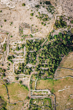 Aerial view of the landscape shows a tapestry of olive groves and stone walls, etched against the Adriatic sky, where history whispers on the breeze, Baska, Primorje-Gorski Kotar County, Croatia.