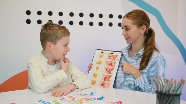 Speech therapist working on articulation with a young boy