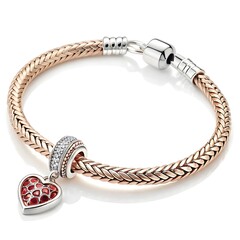 A beautiful rose gold bracelet with a heart shaped charm