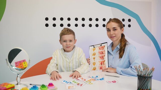 Child speech therapy session with logopedist