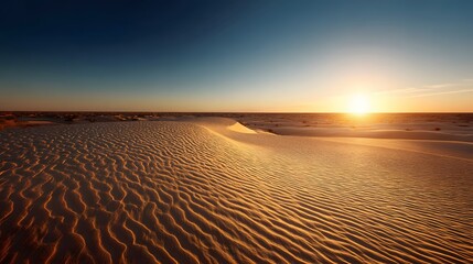 Fototapeta premium Golden Hour Beach Serenity - A Breathtaking Sunset Over Sandy Shores and Ocean Waves.