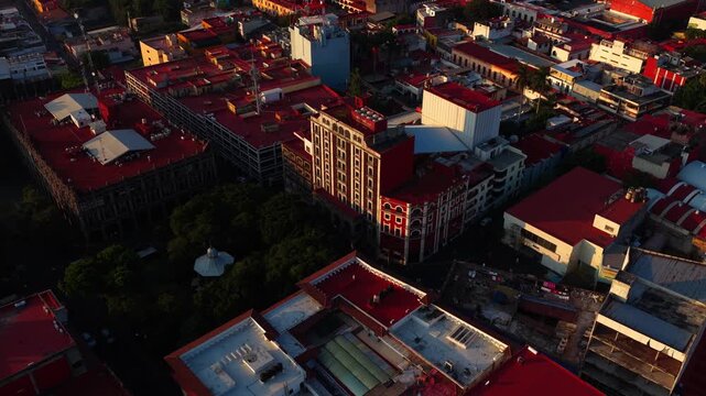 Aerial crane down shot of Teatro Ocampo at sunrise in Cuernavaca