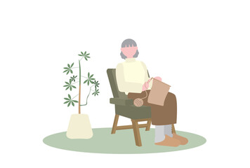 一人かけソファで編み物をするシニア女性