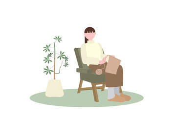 ソファで編み物をする女性