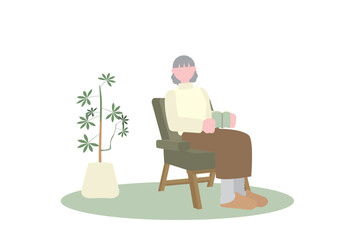 一人がけソファで本を読むシニア女性