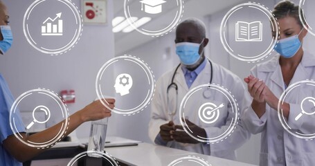Offering nurse blue scrubs handing sanitizer at clinic reception with lab coats masks overlay icons
