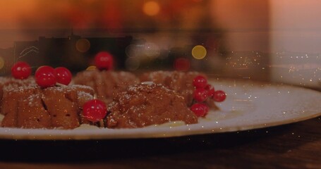 Displaying mini chocolate bundt cakes on white plate on dark wooden table, topped with red currants