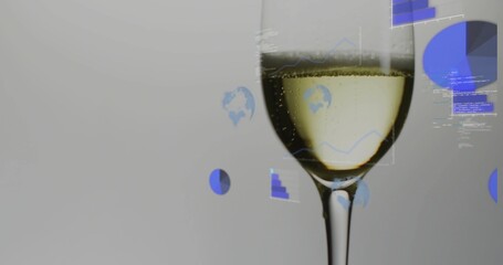 Displaying flute holding light yellow liquid with rising bubbles in studio, blue data overlays