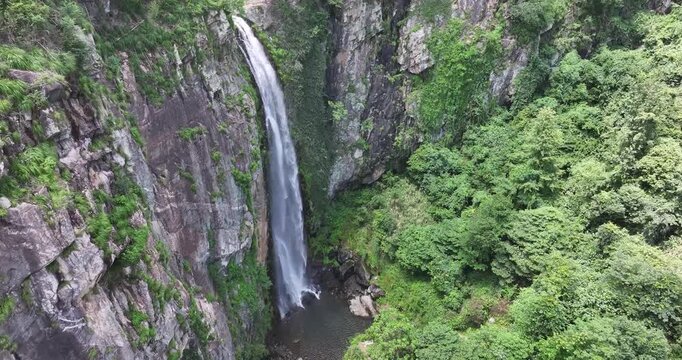 Close-up overhead drone footage of Jade Curtain Waterfall (Yu Lian Spring) in Lushan Mountain, Jiangxi Province, China.