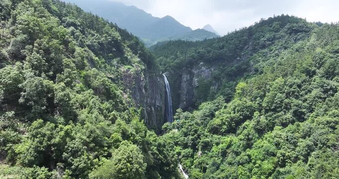 Aerial drone footage of Jade Curtain Waterfall (Yu Lian Spring) cascading from southern slope in Lushan Mountain, Jiangxi Province, China.