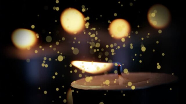 Shot opening, tealight candle leaning and flickering, particles drifting to show warm glow