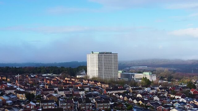 DVLA Building in Swansea surrounded by suburban houses with nearby forest. Office block used for storing UK vehicle and driver details.
