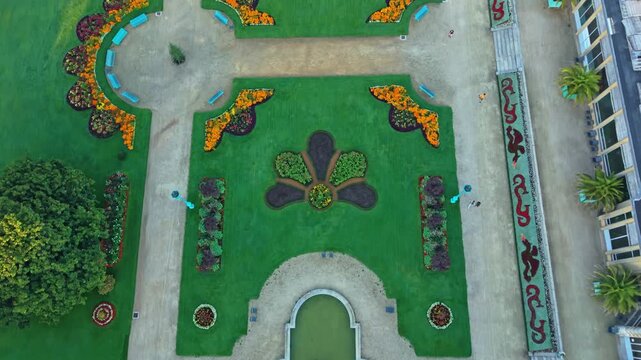 Top down aerial of Parc du Thabor establishing geometric garden paths and lawns in Rennes, textured colorful designs