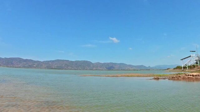 Calm reservoir landscape at Timah Tasoh Lake in Perlis Malaysia with blue sky