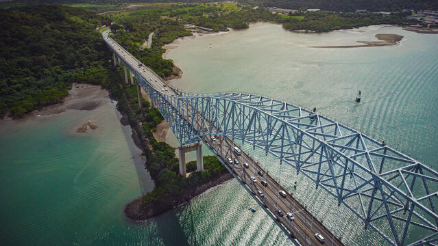 Stunning aerial view of the Bridge of the Americas over the Panama Canal showcasing global trade, iconic architecture, tropical nature and the powerful connection between two continents