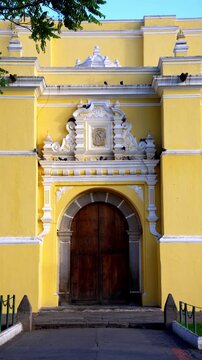 Vertical View Of Ornate Baroque Facade And Entrance Of The Iglesia de La Merced In Antigua Guatemala, Central America. Static Shot