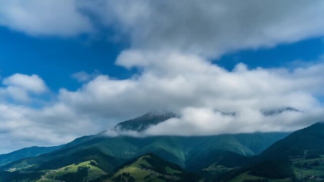 mountain range landscape with green hills and blue cloudy sky
